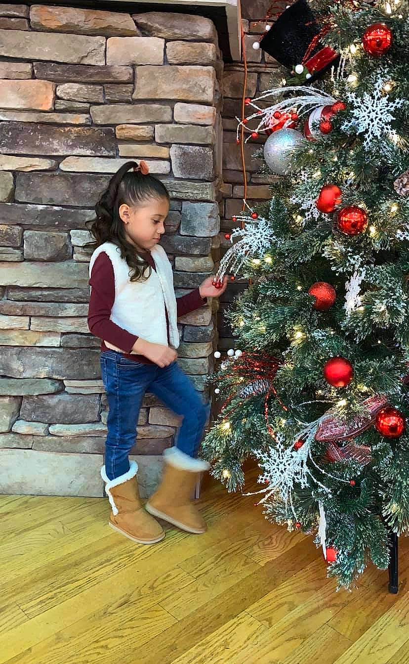 Eleyna is registered to the contest to win money with this photo: child, christmas, christmas_decoration, christmas_eve, christmas_ornament, christmas_tree, colorado_spruce, conifer, event, fir, holiday, holiday_ornament, interior_design, person, pine_family, plant, toddler, tradition, tree, wood