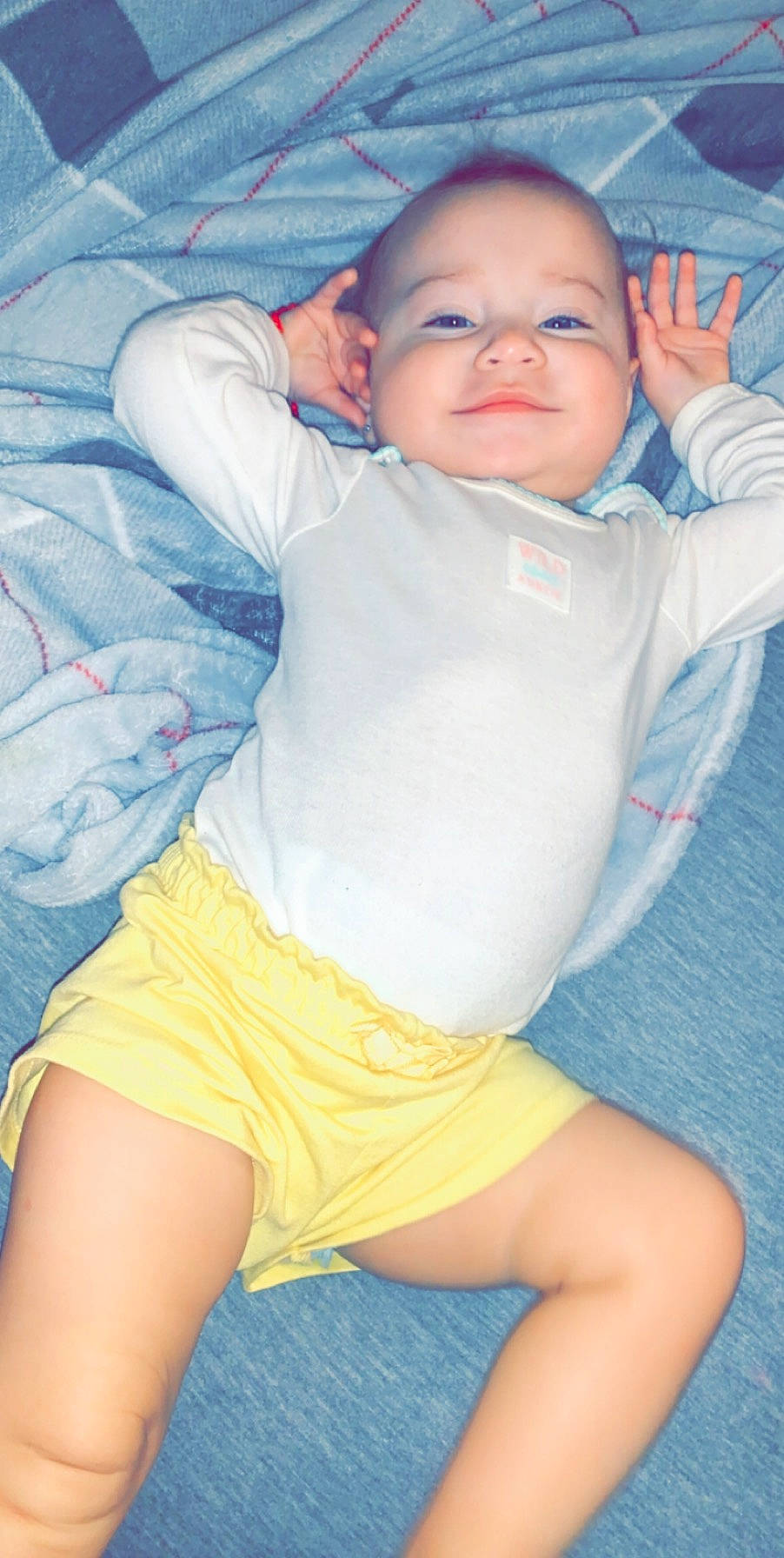 Amalia is registered to the contest to win money with this photo: abdomen, arm, baby, blue, cheek, child, elbow, human_leg, joint, knee, leg, person, sitting, skin, sleep, smile, stomach, thigh, toddler