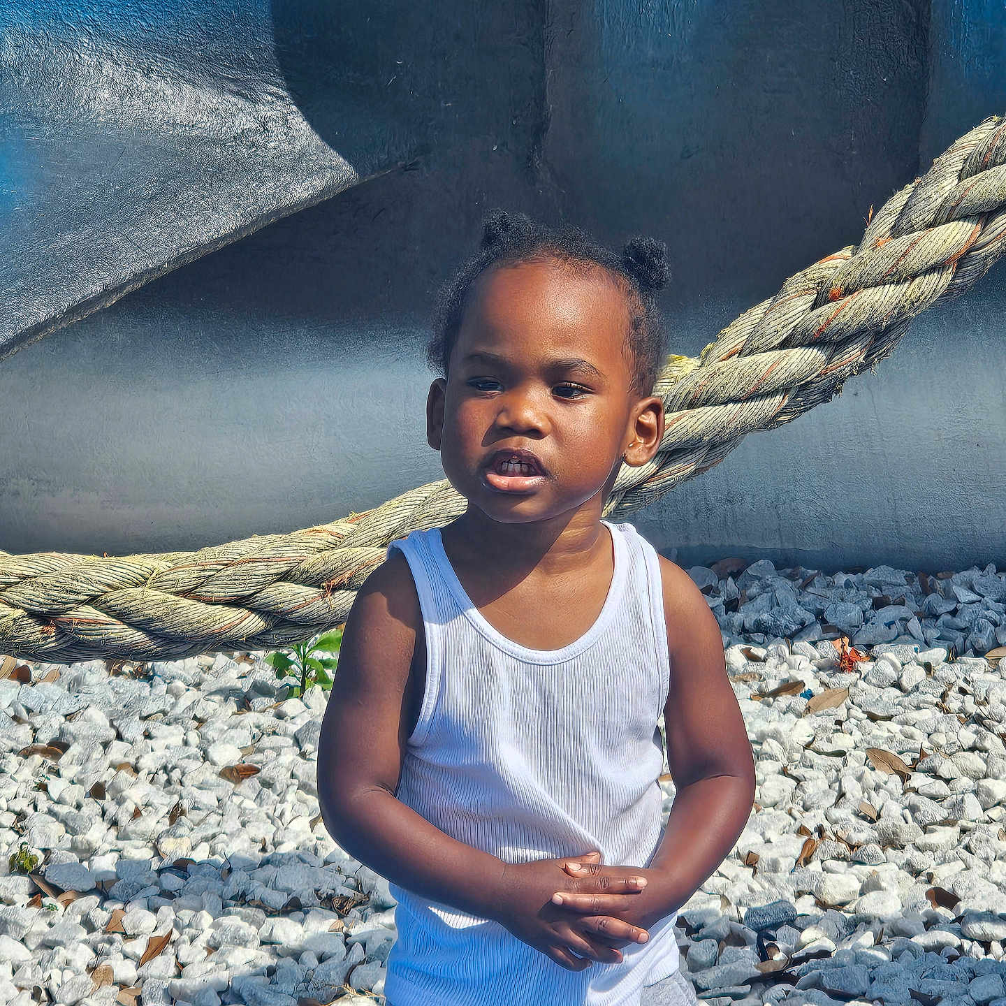 Kannon is registered to the contest to win money with this photo: blackhair, child, clothing, face, female, girl, gravel, hair, happy, head, jeans, pants, pebble, person, photography, portrait, road, rock, sleeve, smile