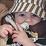 Adriano a rejoint le concours — aidez-le/la à gagner de superbes lots ! baby, child, face, hat, bucket_hat, pacifier, toy, beads, lion_toy, hand, car_seat, blanket, brown, white, striped, cute, infant, closeup, comfort, indoors