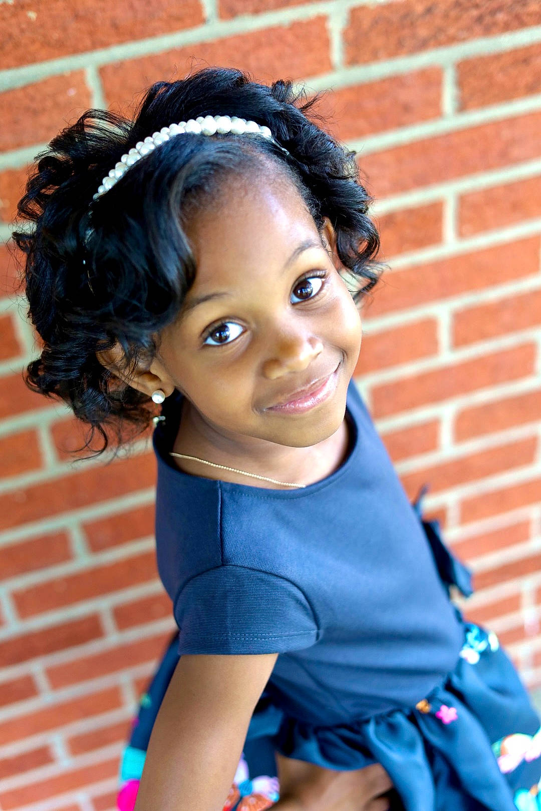 Sareya is registered to the contest to win money with this photo: baby_toddler_clothing, black_hair, blue, brick, brickwork, child, chin, cool, doll, electric_blue, eye, eyelash, hair, hairstyle, happy, head, jewellery, joy, lip, person