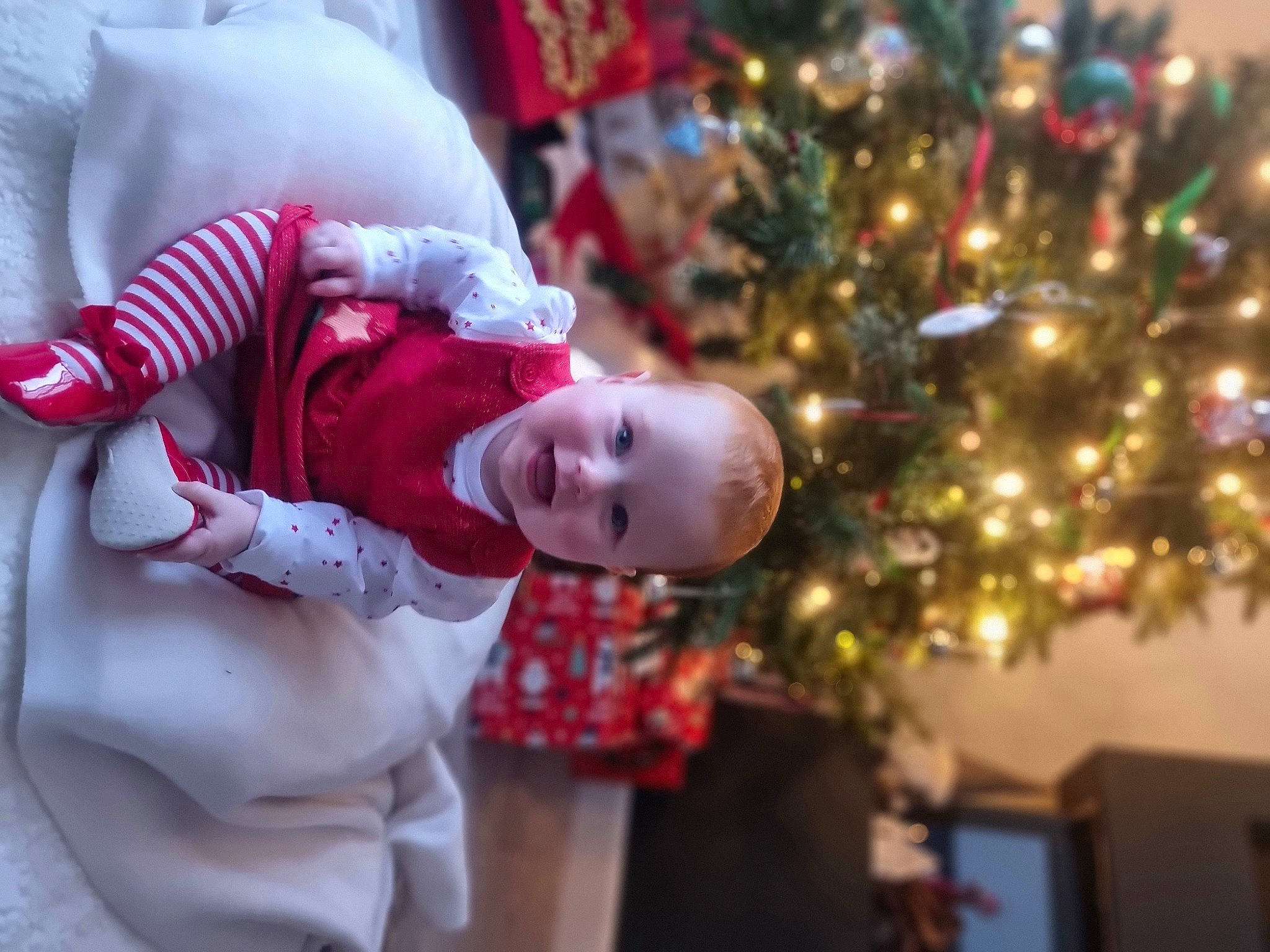 Skye joined the competition — help win amazing prizes! baby, baby_toddler_clothing, child, christmas, christmas_decoration, christmas_ornament, christmas_tree, conifer, event, facial_expression, fun, happy, holiday, holiday_ornament, human_body, joy, ornament, person, plant, toddler