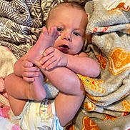 Jameson is registered to the contest to win money with this photo: baby, diaper, foot, hand, blanket, pattern, skin, infant, cute, child, laying, comfort, toddler, expression, closeup, indoors, soft, cozy, cute_pose, person