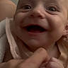 Zavia is registered to the contest to win money with this photo: baby, smile, hand, finger, close_up, infant, skin, face, joy, expression, person, human, cute, holding, warmth, intimate, soft_lighting, portrait, newborn, happy