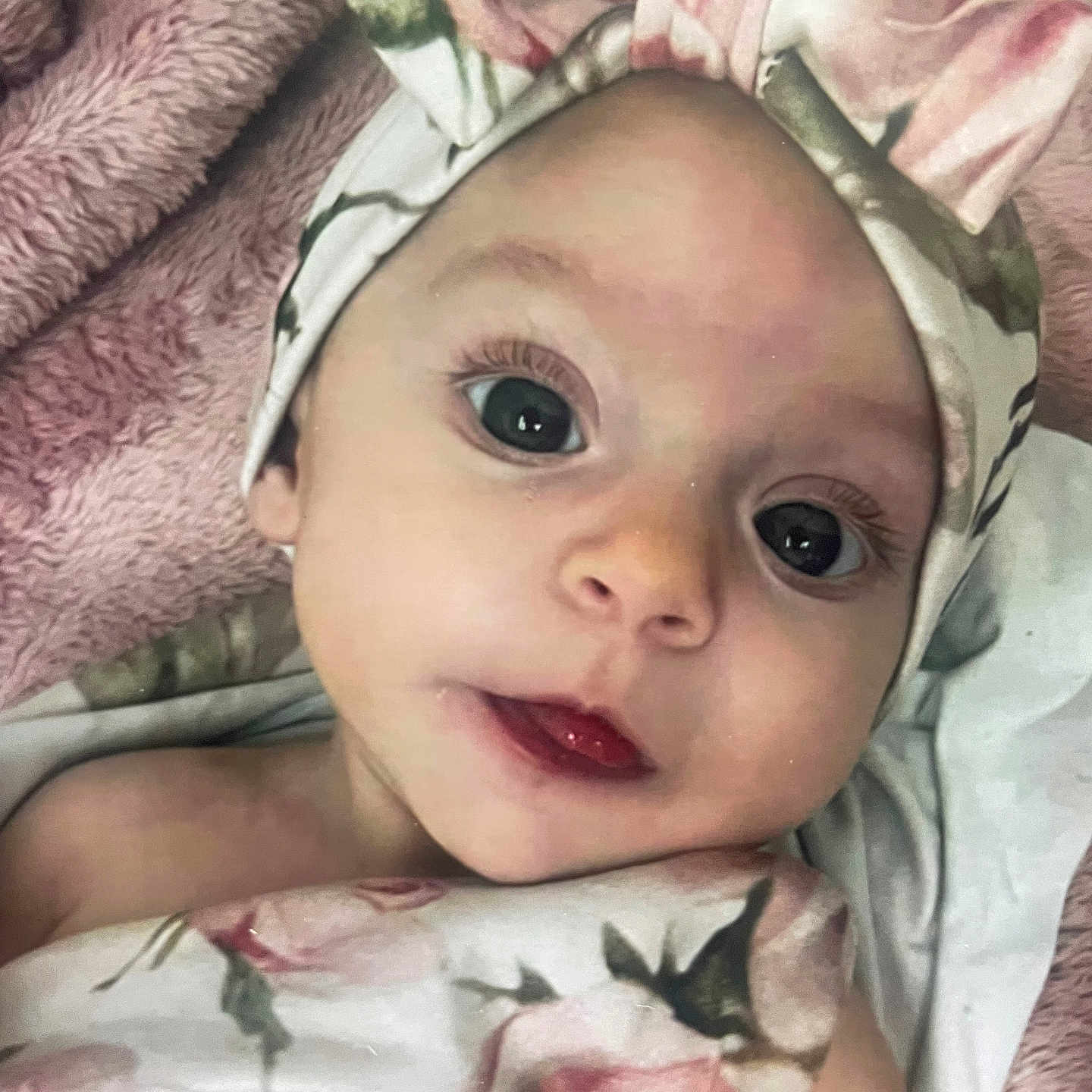 Zavia is registered to the contest to win money with this photo: baby, infant, face, headband, blanket, floral, pink, soft_texture, closeup, portrait, cute, child, human, skin, eyes, mouth, sleepwear, resting, newborn, indoors