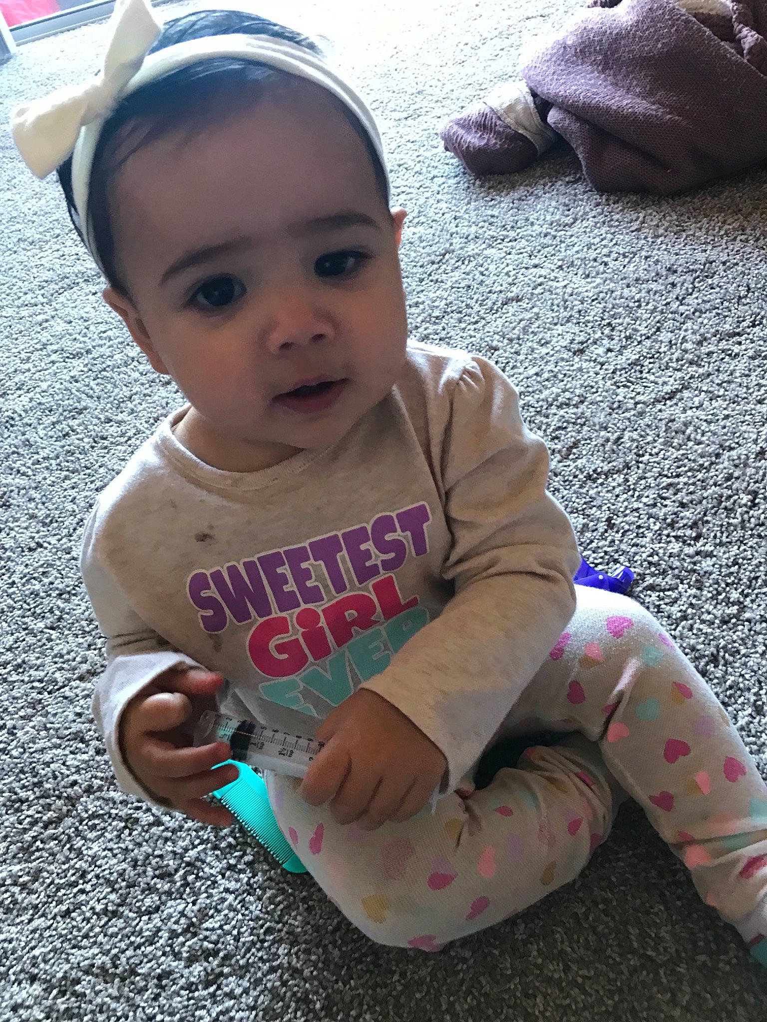 Alayah is registered to the contest to win money with this photo: arm, child, cool, day, fun, girl, headgear, infant, person, pink, product, sitting, skin, toddler