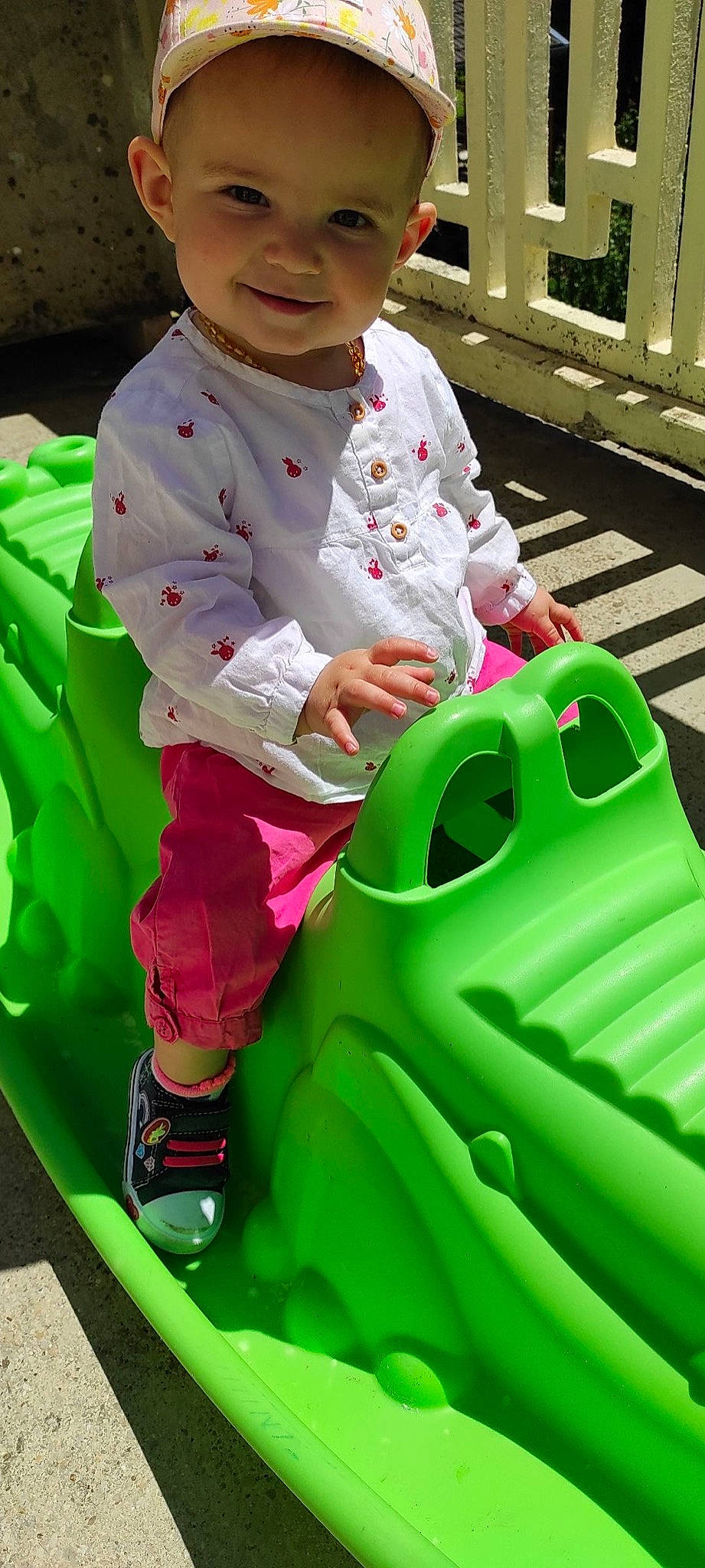 Joy participe au concours pour gagner de l'argent avec cette photo : baby_toddler_clothing, child, chute, fun, grass, green, happy, hat, joy, leisure, outerwear, person, photograph, pink, product, recreation, riding_toy, sleeve, snapshot, toddler