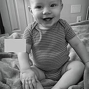 Karson joined the competition — help win amazing prizes! baby, child, smiling, onesie, blanket, sitting, happy, infant, soft, cozy, monochrome, black_and_white, foot, hand, room, clothing, texture, portrait, indoor, cute