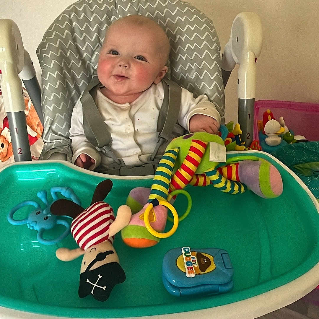 Ollie joined the competition — help win amazing prizes! baby, chair, crib, cushion, cutlery, diningtable, face, furniture, happy, head, homedecor, indoors, infantbed, person, photography, playarea, portrait, spoon, table, toy