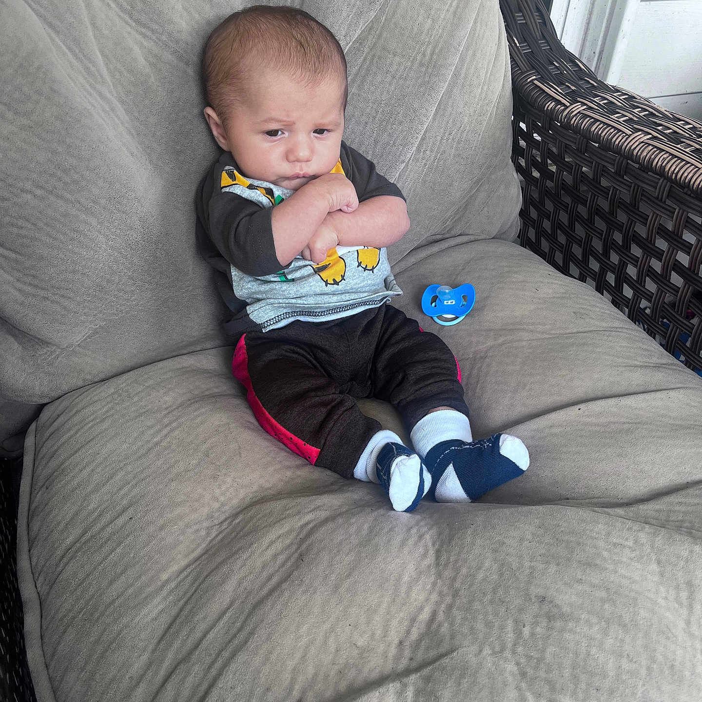 Talon joined the competition — help win amazing prizes! baby, chair, child, clothing, cushion, expression, face, footwear, furniture, hands, head, indoor, infant, pacifier, pants, person, shirt, sitting, sock, wicker