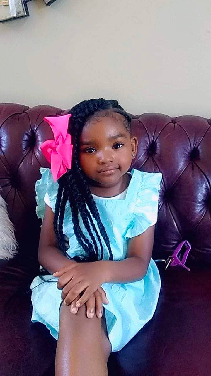 Taylen is registered to the contest to win money with this photo: baby, beauty, black, black_hair, cheek, child, face, fun, hair, hairstyle, happy, head, human, long_hair, nose, person, pink, sitting, skin, smile