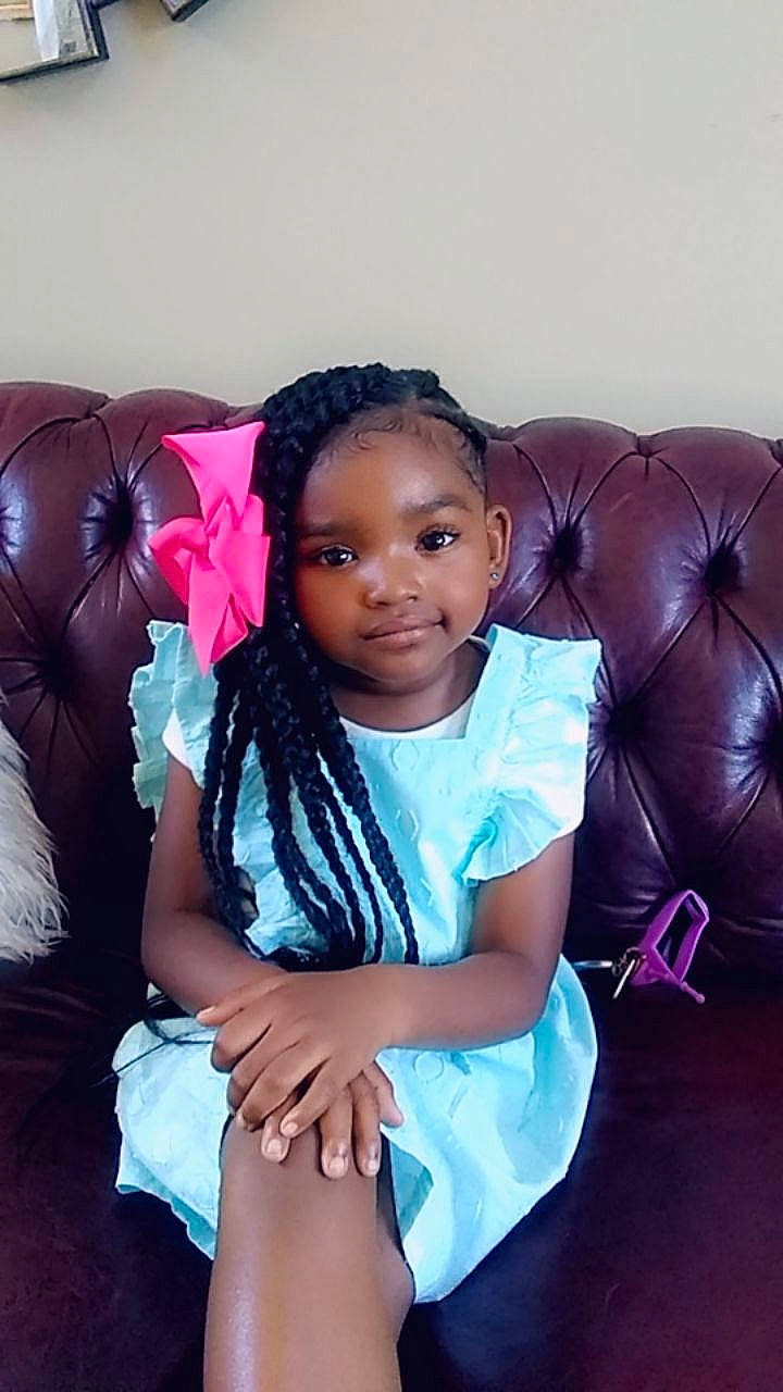 Tahiry is registered to the contest to win money with this photo: baby, beauty, black, black_hair, cheek, child, daughter, face, fun, happy, head, long_hair, person, pink, sitting, skin, toddler