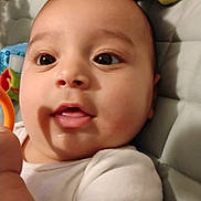 Rosalina joined the competition — help win amazing prizes! baby, infant, toy, plush_toy, dinosaur, face, cute, child, white_clothing, hand, close_up, indoor, expression, skin, eyes, mouth, quilting, soft_toy, lying_down, curious