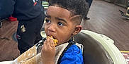 Zander joined the competition — help win amazing prizes! child, boy, haircut, barbershop, snack, chair, curly_hair, blue_shirt, person, indoor, floor, wood_floor, people, furniture, wall_decor, vinyl_records, guitar, casual_clothing, hair_style, waiting