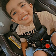 Zander joined the competition — help win amazing prizes! child, car_seat, smiling, curly_hair, sippy_cup, casual_clothing, car_interior, seatbelt, young_child, happy, foot, toddler, safety, portrait, cute, baby, kid, travel, family, interior