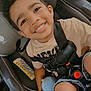 child, car_seat, smiling, curly_hair, sippy_cup, casual_clothing, car_interior, seatbelt, young_child, happy, foot, toddler, safety, portrait, cute, baby, kid, travel, family, interior
