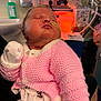 Olivia is registered to the contest to win money with this photo: baby, infant, sleeping, pink_sweater, onesie, feeding_tube, hospital, medical_equipment, indoor, closeup, child, person, healthcare, newborn, soft_lighting, knitted_clothing, cute, peaceful, resting, care