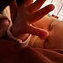 Olivia is registered to the contest to win money with this photo: baby, sleeping, hand, face, infant, closeup, indoors, curtains, soft_light, peaceful, resting, child, young, portrait, skin, head, cozy, warm_tone, fingers, blanket