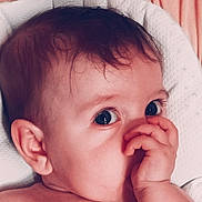 Flora participe au concours pour gagner de l'argent avec cette photo : baby, infant, face, hand, thumb, eyes, skin, hair, ear, cushion, texture, comfort, closeup, portrait, child, resting, cute, soft, background, peach