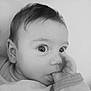 baby, black_and_white, blanket, child, close_up, cozy, curious, cute, expression, eyes, face, hand, indoors, infant, newborn, portrait, sleepwear, soft_lighting, thumb, young_child