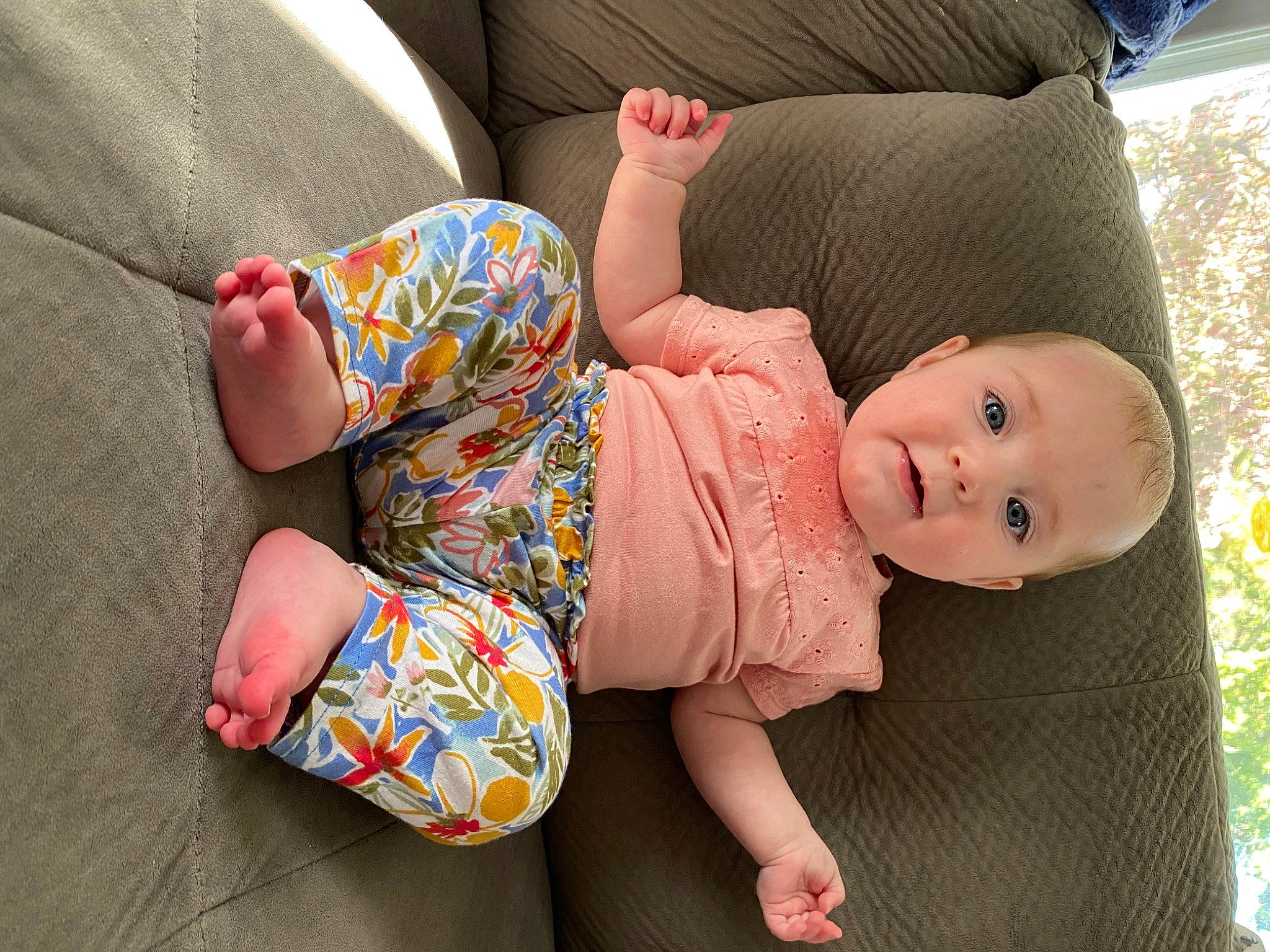 Emmalyn is registered to the contest to win money with this photo: baby, baby_toddler_clothing, child, comfort, dress, facial_expression, finger, flooring, grass, human_body, joint, leg, mammal, person, pink, plant, skin, sleeve, thigh, toddler