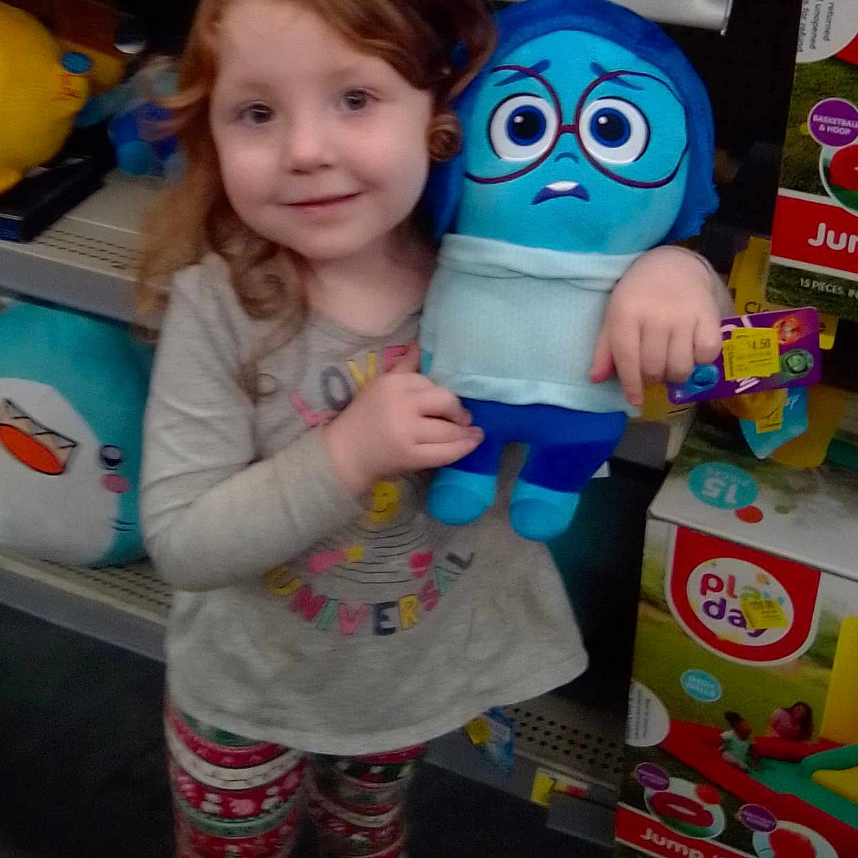 Montana is registered to the contest to win money with this photo: candy, child, clothing, costume, doll, face, female, food, footwear, girl, head, indoors, person, photography, plush, portrait, shoe, sweets, t_shirt, toy