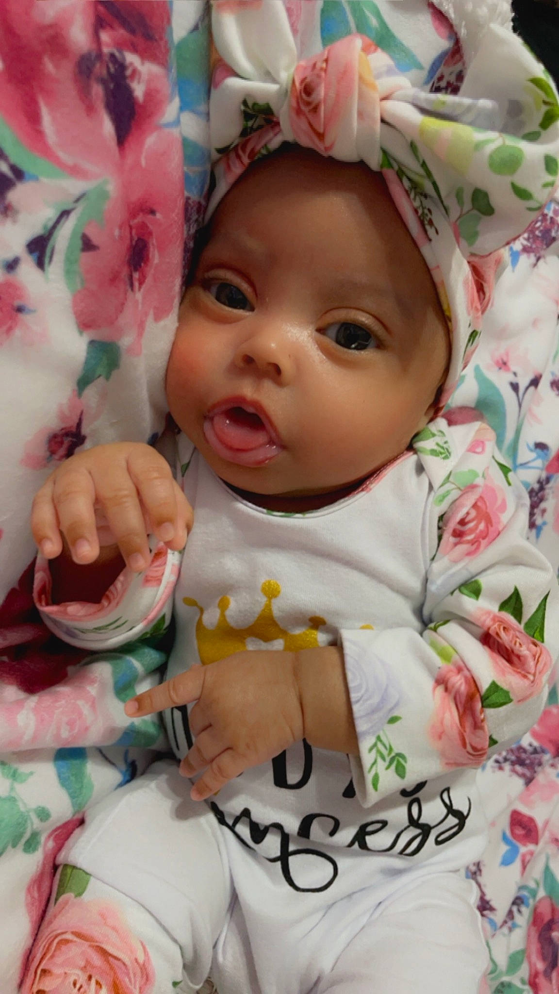 Skylar is registered to the contest to win money with this photo: baby, baby_products, baby_toddler_clothing, cheek, child, eyelash, gesture, happy, headwear, linens, nail, nose, pattern, peach, person, petal, pink, skin, sleeve, smile