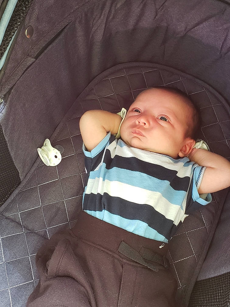 Baron is registered to the contest to win money with this photo: baby, baby_carriage, baby_products, baby_toddler_clothing, brown, car_seat, chair, cheek, child, comfort, hairstyle, iris, mammal, pattern, person, product, sitting, skin, sleeve, tints_and_shades