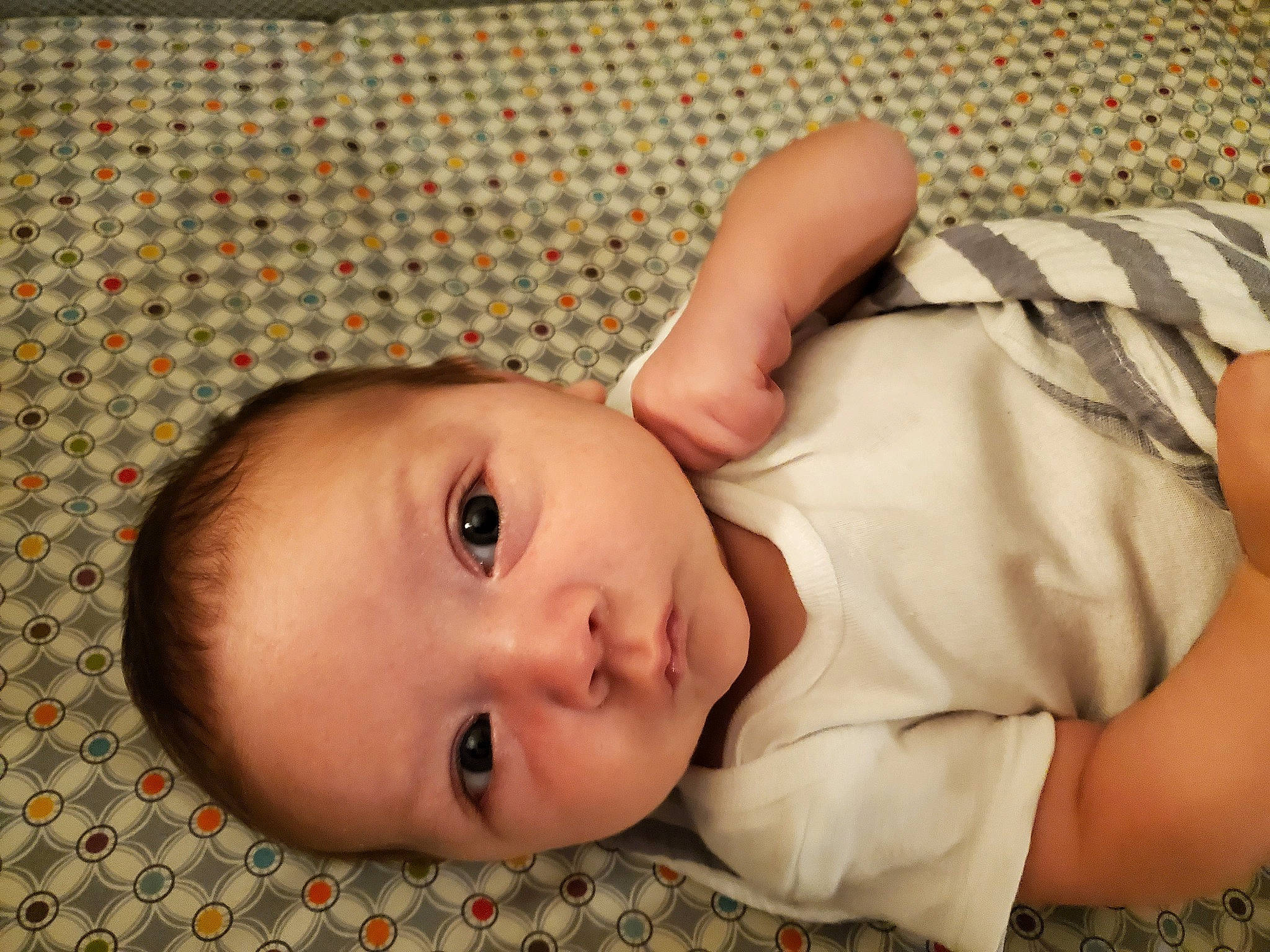 Baron is registered to the contest to win money with this photo: baby, baby_products, baby_toddler_clothing, cheek, child, comfort, eye, eyelash, grass, head, human_body, linens, lip, nose, pattern, person, sitting, skin, sleeve, toddler