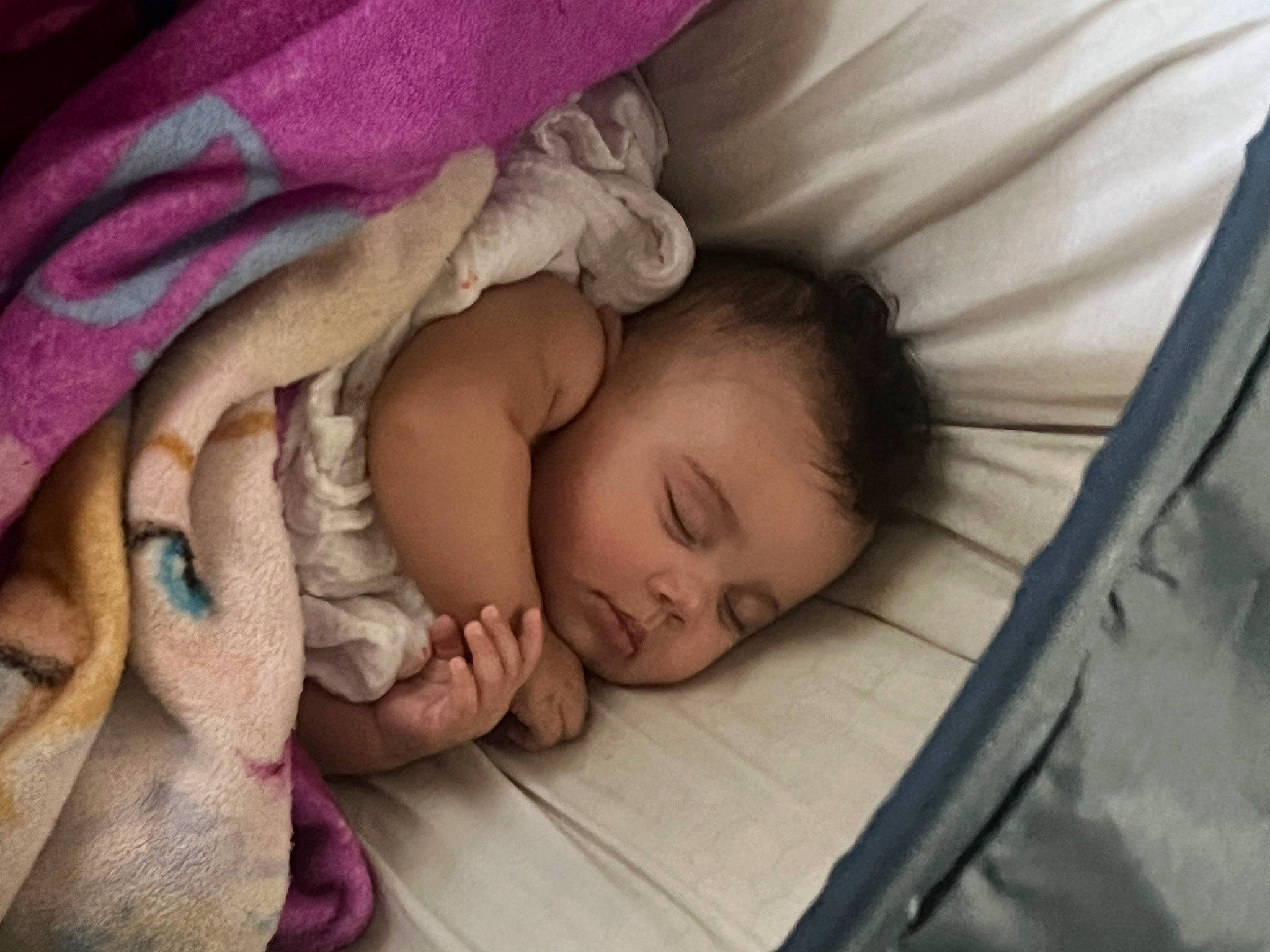 Ivy Rose is registered to the contest to win money with this photo: baby, baby_toddler_clothing, bed, bedtime, cheek, child, chin, comfort, eyebrow, finger, grass, head, human_body, iris, linens, nose, person, skin, textile, toddler