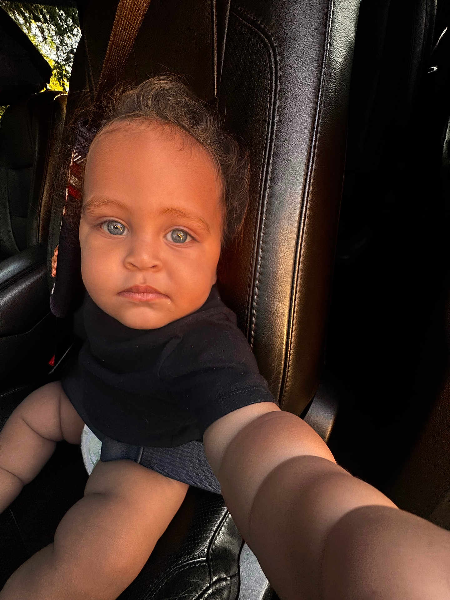Ahaziah joined the competition — help win amazing prizes! baby, child, car_seat, blue_eyes, black_shirt, leather_seat, car_interior, seatbelt, infant, arm, cute, portrait, looking_at_camera, young_child, skin, human, sitting, one_person, indoor, closeup