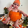 baby, pumpkin, halloween, hat, plant, flowerpot, candle, floor, orange, child, cute, decorations, holiday, smiling, face, indoor, tablecloth, toy, spooky, costume