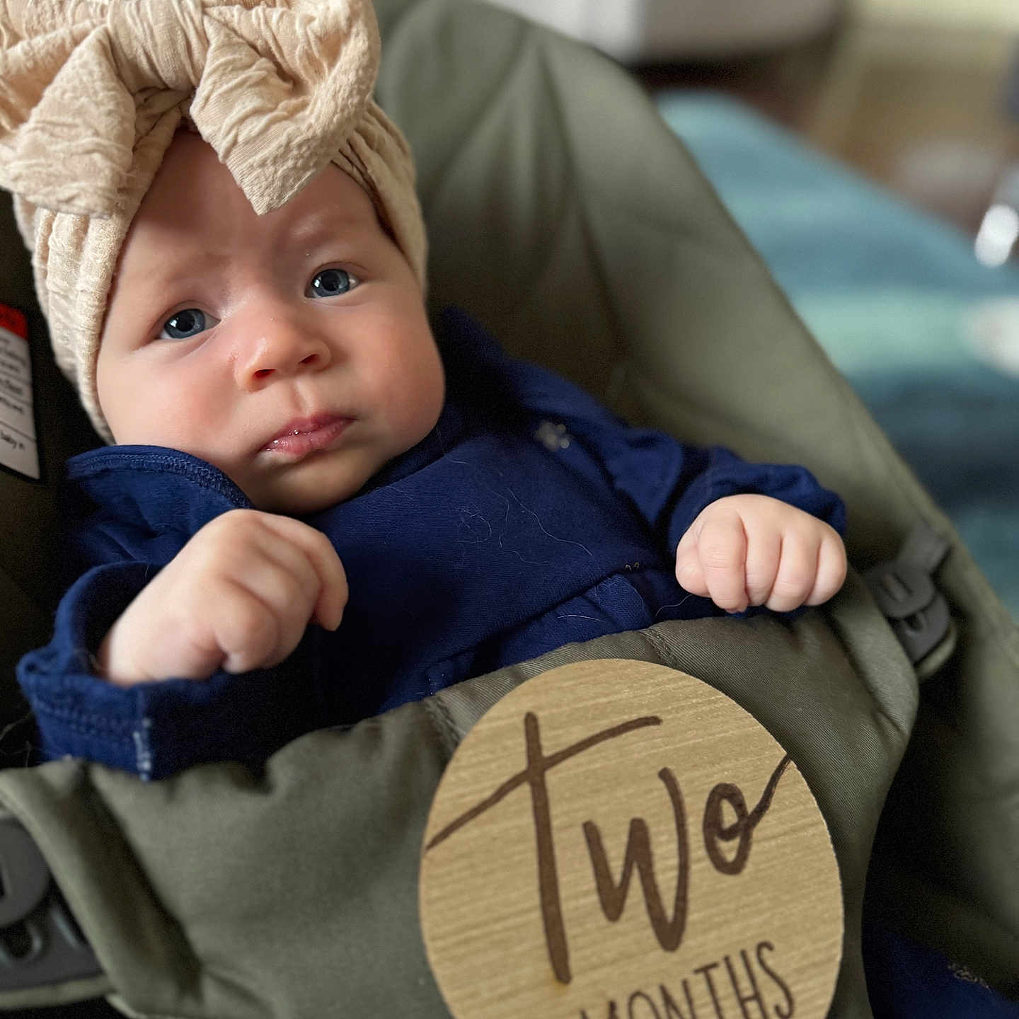 Evelyn joined the competition — help win amazing prizes! baby, bodypart, bonnet, cap, clothing, couch, face, finger, furniture, hand, hat, head, hood, hoodie, knitwear, person, photography, portrait, sweater, sweatshirt