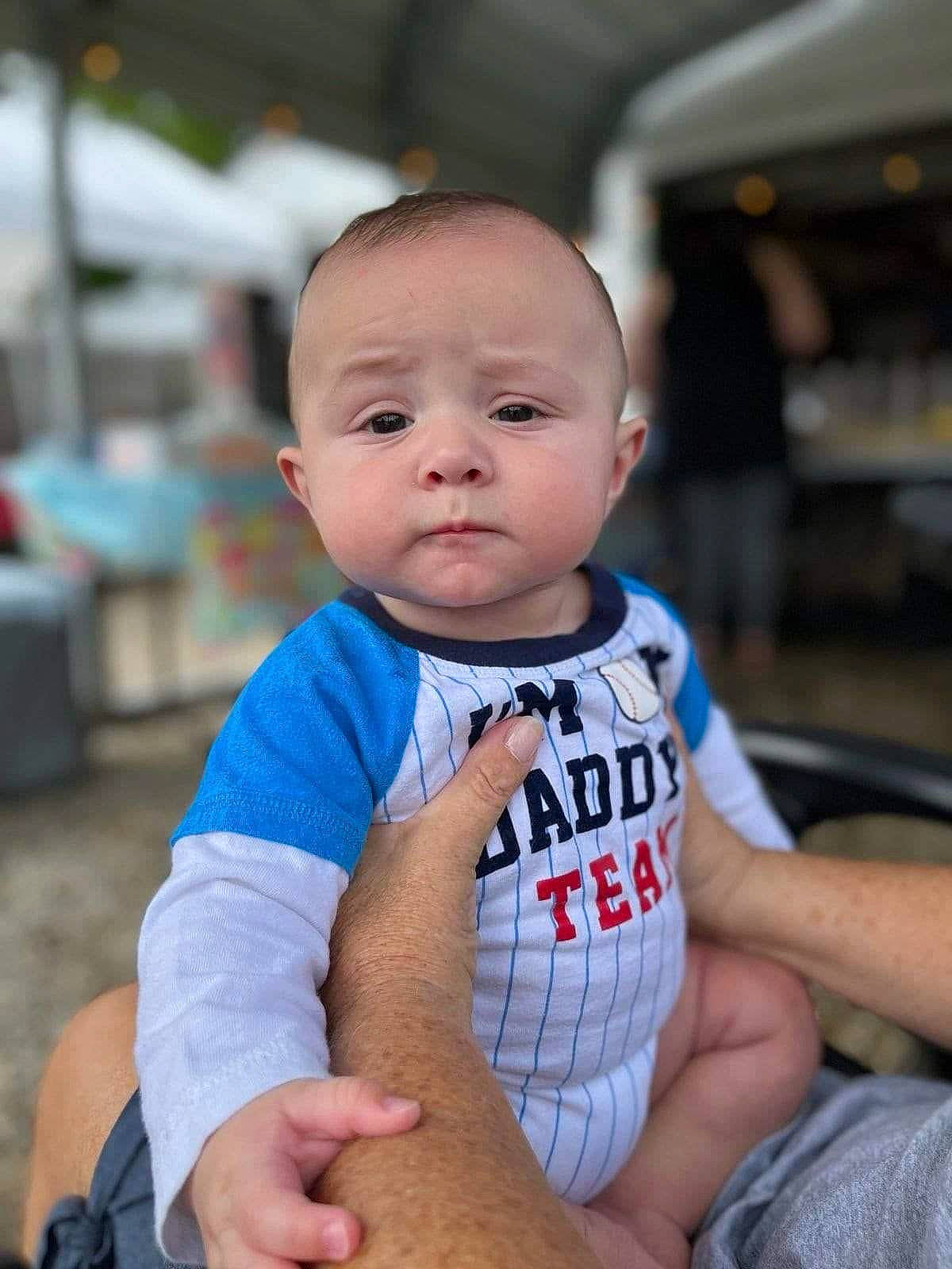 Yamir is registered to the contest to win money with this photo: baby, baby_toddler_clothing, cheek, child, elbow, electric_blue, eye, fun, grass, hand, happy, person, sitting, skin, sleeve, smile, sorrow, t_shirt, thumb, toddler