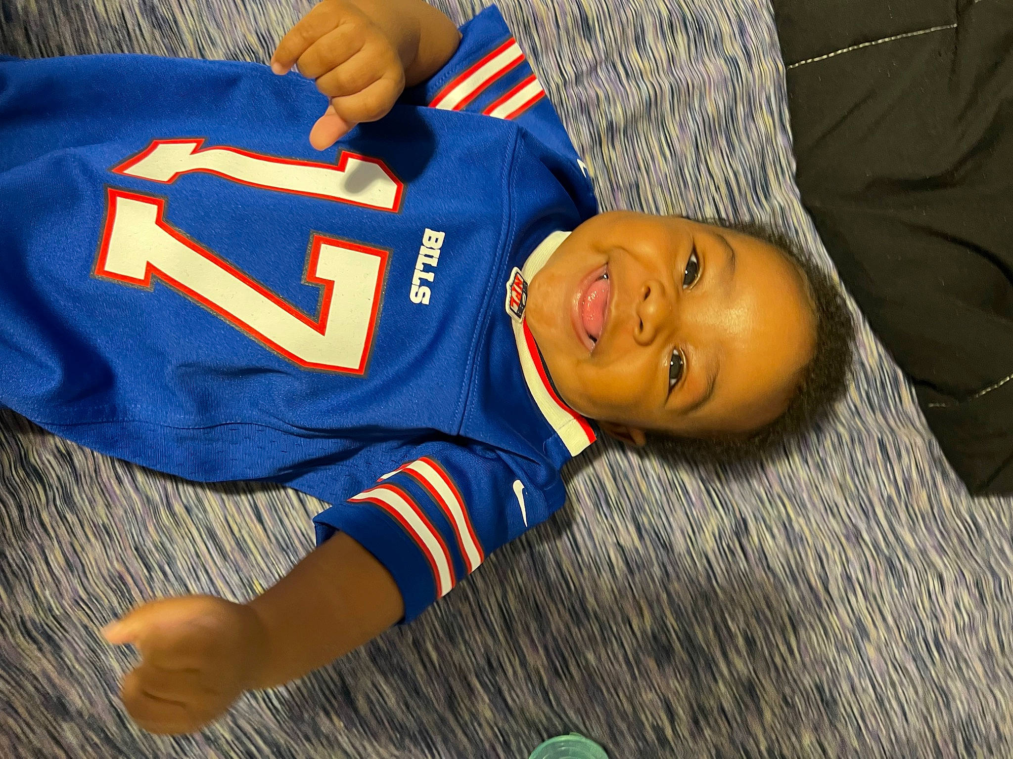 Brandon is registered to the contest to win money with this photo: baby_toddler_clothing, carmine, child, elbow, electric_blue, flooring, grass, happy, headgear, jersey, joy, person, player, sleeve, smile, sports_jersey, sports_uniform, sportswear, t_shirt, toddler