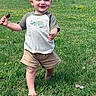 toddler, child, grass, outdoor, smiling, barefoot, shorts, tshirt, greenery, daylight, nature, happy, walking, field, young_child, person, casual_clothing, playful, summer, park