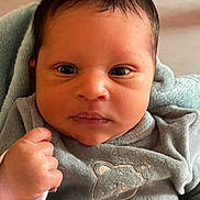 Diogo Abel participe au concours pour gagner de l'argent avec cette photo : baby, infant, face, hand, fist, clothing, grey_outfit, blanket, portrait, closeup, cute, young_child, indoors, expression, newborn, person, cozy, soft_texture, sleeve, child