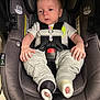 Owen is registered to the contest to win money with this photo: baby, car_seat, child, closeup, clothing, comfortable, cute, face, footwear, head, indoors, infant, mismatched_socks, person, resting, safety, seatbelt, sitting, straps, young_child