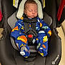 infant, baby, car_seat, safety_1st, sleeping, onesie, space_theme, colorful_clothing, child, strapped_in, head_support, indoor, seatbelt, baby_gear, peaceful, newborn, transportation, nap_time, black, soft_lighting