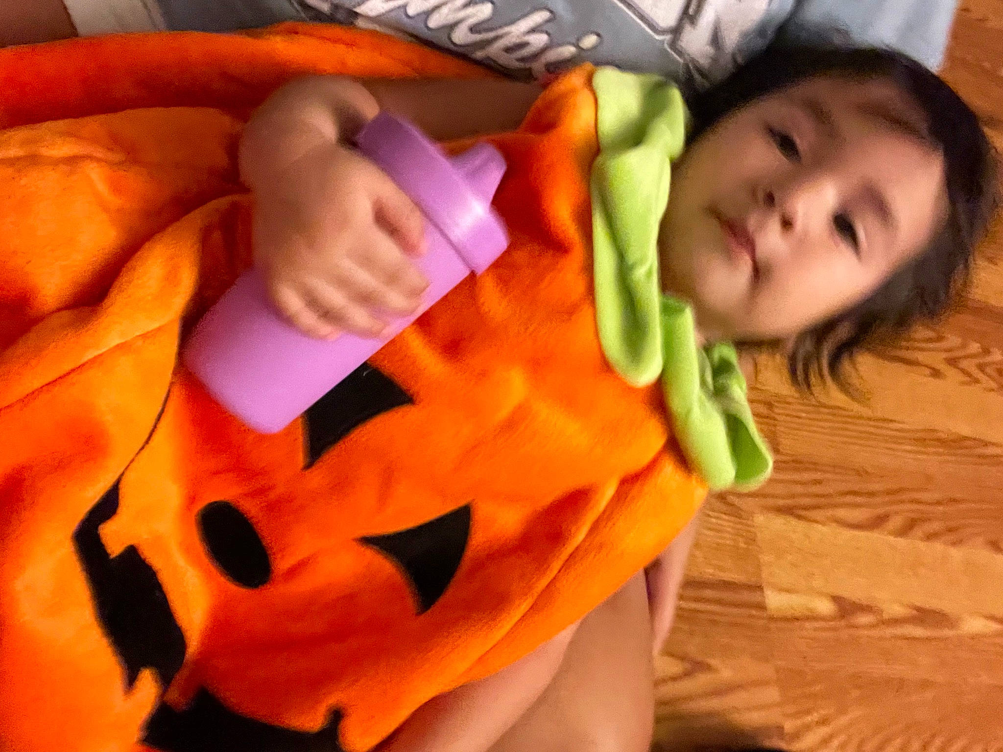 Amelia is registered to the contest to win money with this photo: baby, baby_products, baby_toddler_clothing, child, comfort, finger, fun, gesture, happy, linens, nail, neck, orange, peach, person, personal_protective_equipment, sleeve, textile, thumb, toddler