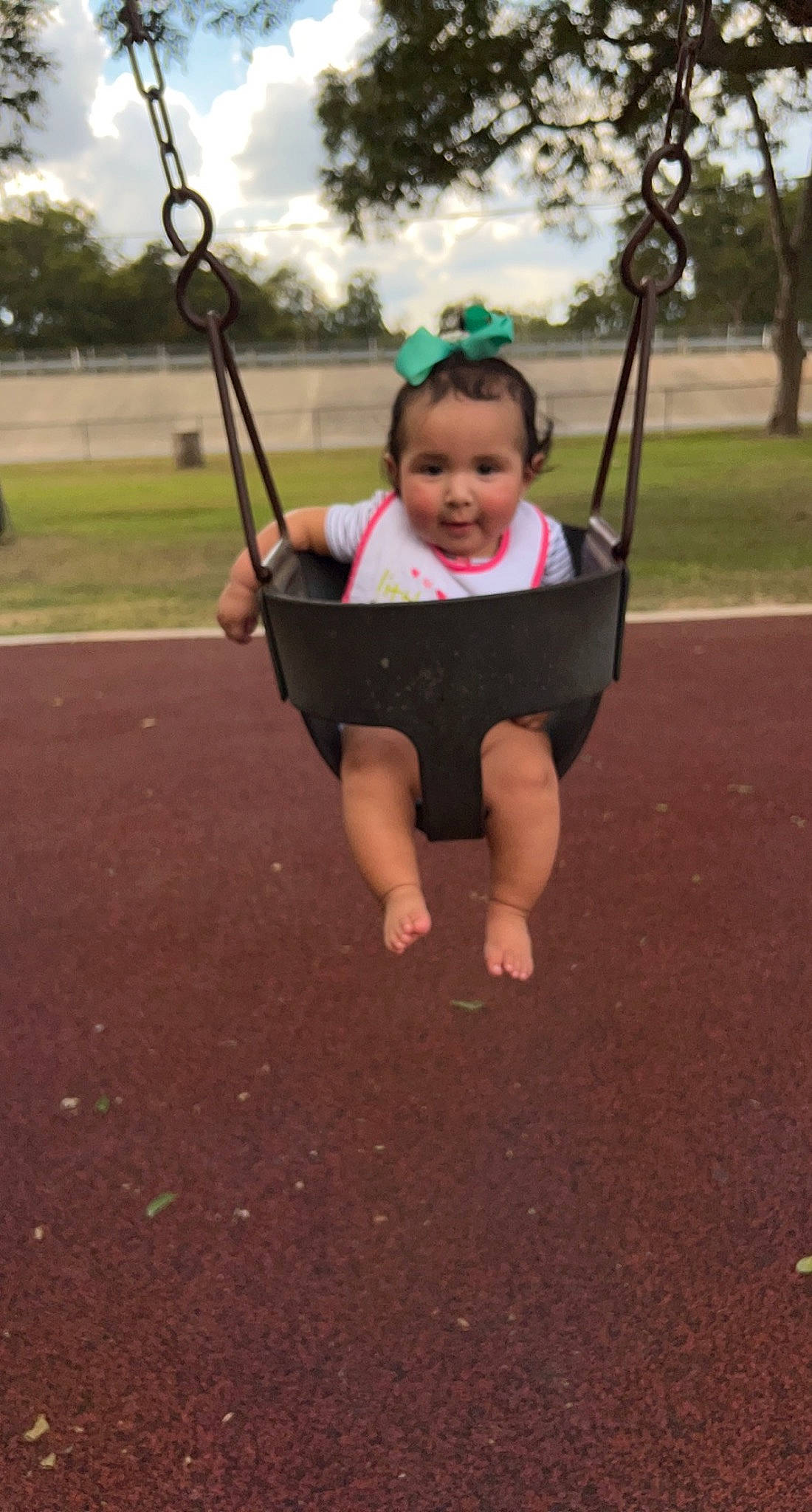 Amelia joined the competition — help win amazing prizes! baby, child, city, fun, grass, happy, head, leisure, outdoor_play_equipment, people_in_nature, person, plant, playground, recreation, sky, sleeve, smile, swing, t_shirt, toddler