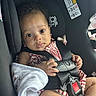 baby, child, car_seat, infant, seatbelt, harness, blanket, clothing, person, face, hand, sitting, indoors, cute, looking_at_camera, curious, safety, transportation, young_child, toddler