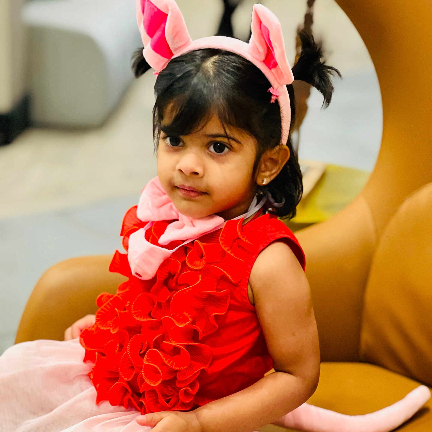 Thiya Tahkshi joined the competition — help win amazing prizes! chair, child, costume, curious, cute, fashion, girl, home, indoor, person, pink_ears, pink_tail, playful, portrait, red_dress, ruffles, seated, smile, tutu, young