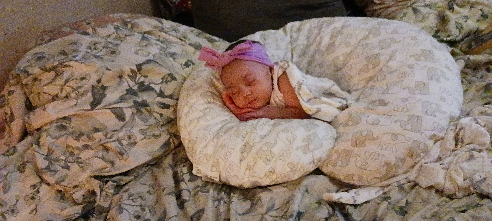 Blair is registered to the contest to win money with this photo: baby, baby_products, baby_toddler_clothing, bedding, bedtime, cap, child, comfort, crawling, flooring, grass, headwear, linens, military_camouflage, nap, person, rock, sitting, sleep, sleeve