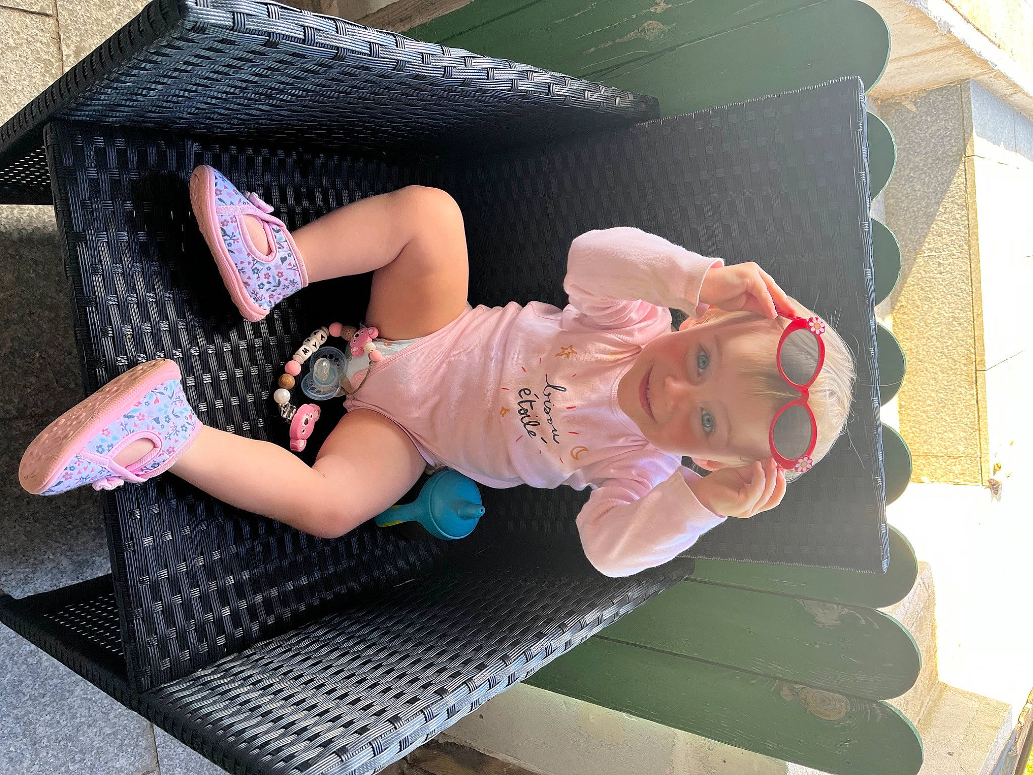 Mya participe au concours pour gagner de l'argent avec cette photo : baby, baby_toddler_clothing, comfort, foot, fun, hat, headwear, human_leg, joy, knee, lap, leg, leisure, outdoor_furniture, person, pink, sandal, shoe, shorts, sneakers