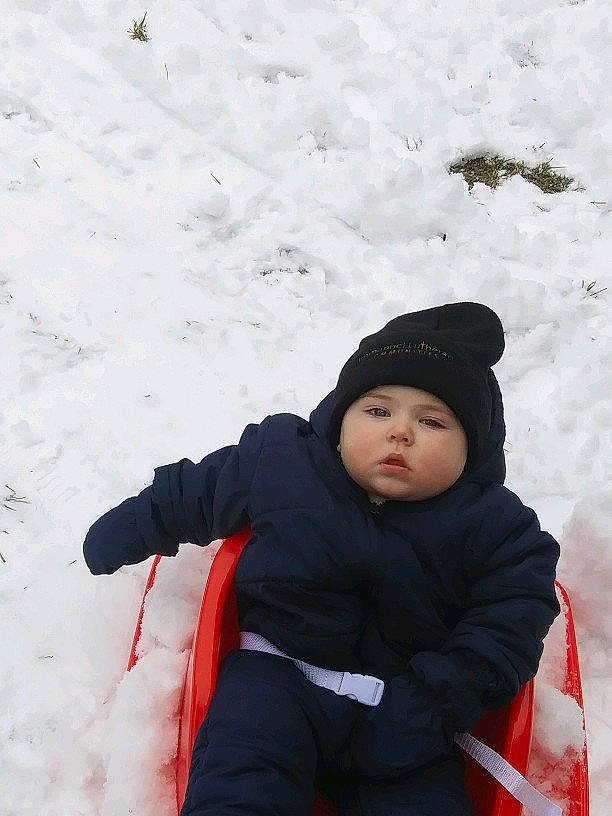 Micah is registered to the contest to win money with this photo: child, freezing, fun, geological_phenomenon, person, playing_in_the_snow, recreation, smile, snow, winter
