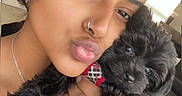 Kali is registered to the contest to win money with this photo: affection, bed, black_dog, blanket, casual, cute, dog, hand, indoor, jewelry, love, nose_ring, pet, portrait, puppy, selfie, striped_shirt, window, woman, young_adult