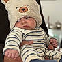 Henri participe au concours pour gagner de l'argent avec cette photo : baby, bear_hat, child, clothing, cozy, cute, expression, face, hand, hat, holding, indoor, infant, pajamas, person, portrait, sleepy, soft_texture, striped_clothing, warm