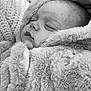 baby, infant, sleeping, blanket, fur, close_up, face, soft_texture, cozy, warm, portrait, cute, child, peaceful, resting, newborn, wrapped, knitted, monochrome, tender