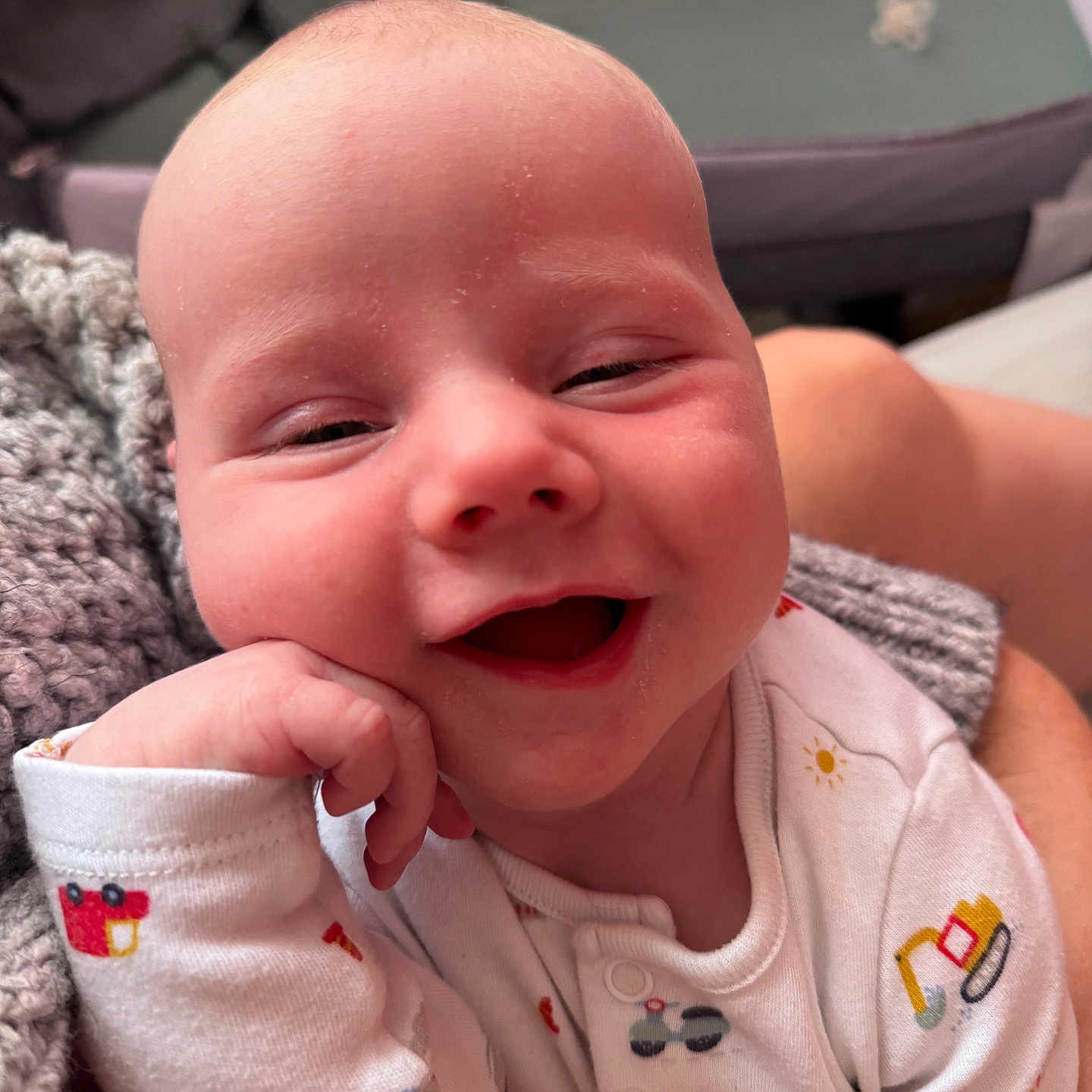 Jenson-James joined the competition — help win amazing prizes! baby, cheek, child, closeup, clothing, cozy, cute, face, hand, happy, head, indoor, infant, knitted_blanket, onesie, person, portrait, sitting, skin, smiling